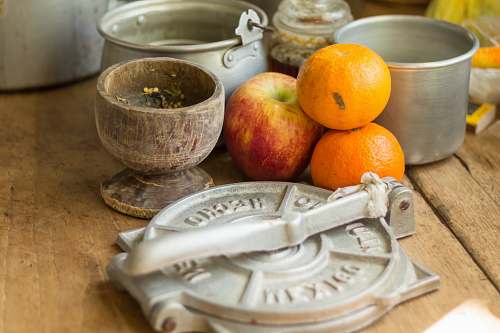 citrus fruit stack of orange and apples by pots on table top fruit